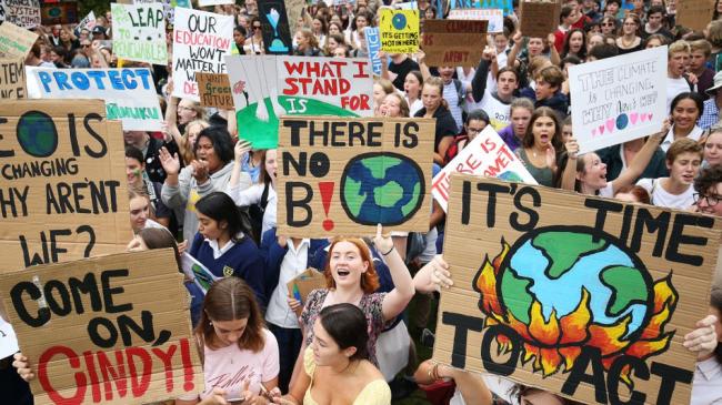 Students marching in the street for the climate strike.